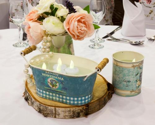 a candle holder on a table with a vase of flowers at Holiday Inn Newcastle Gosforth Park by IHG in Newcastle upon Tyne