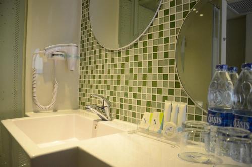 a bathroom with a sink and a mirror at Ion Bali Benoa in Nusa Dua