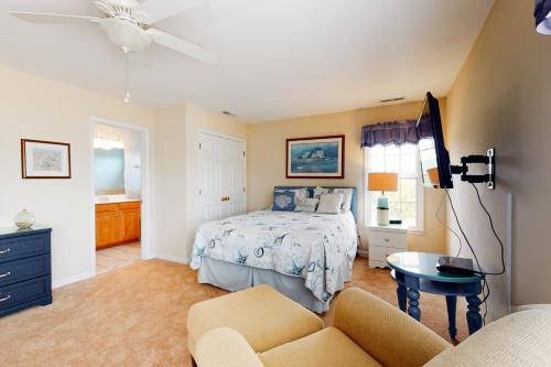 a bedroom with a bed and a couch at Bear Trap Dunes - 1 Village Green in Ocean View