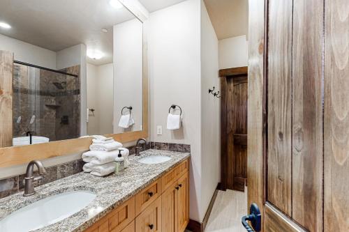 a bathroom with two sinks and a large mirror at Frisco Frolic in Frisco