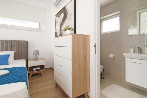 a small bedroom with a bed and a sink at Villa Medusa in Protaras