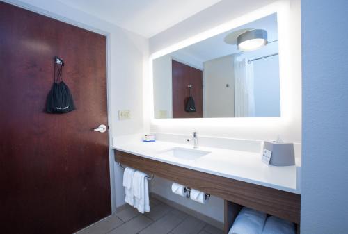 ein Bad mit einem Waschbecken und einem Spiegel in der Unterkunft Holiday Inn Express & Suites Tupelo, an IHG Hotel in Tupelo