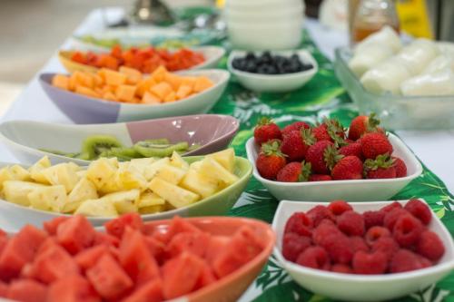 a table topped with bowls of fruits and vegetables at Anjali Casa Divina in Sayulita