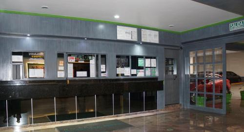 a lobby of a building with a bar in it at Hotel Corona Real in Mexico City
