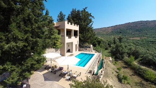 an external view of a villa with a swimming pool at Villa Kalamitsi Luxury Villa in Apokorona Xania in Kariá