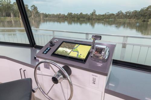 a machine on a boat with a view of a river at All Seasons Houseboats in Mildura