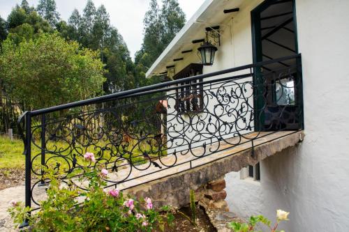 a balcony of a house with a black railing at Villa Patty in Tibasosa