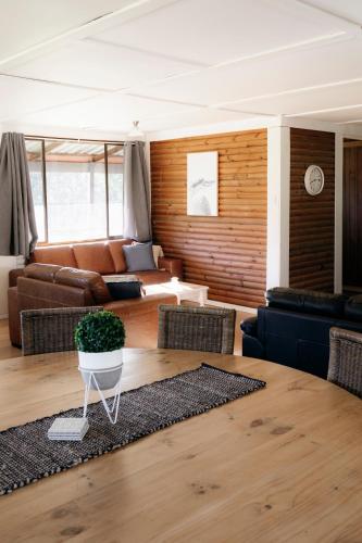 a living room with a couch and a table at Palmers Lane Estate Hunter Valley in Pokolbin