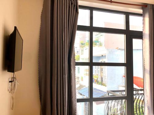 a window with a view of a balcony at Bien Dong Green Hotel in Ho Chi Minh City