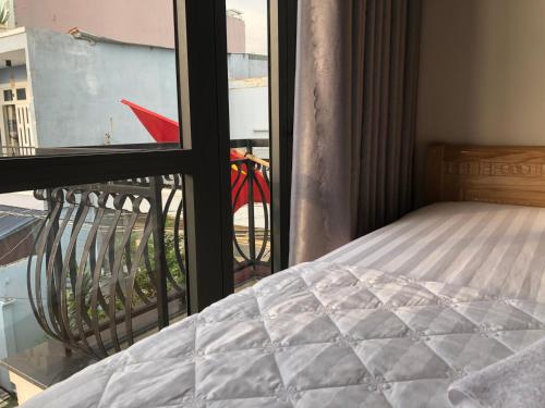a bedroom with a bed and a view of a city at Bien Dong Green Hotel in Ho Chi Minh City