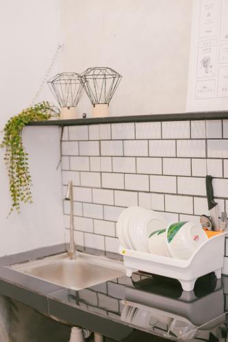 a kitchen counter with a sink and a bath tub at Langkawi Green View Cottage in Pantai Cenang