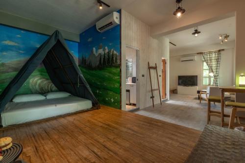 a bedroom with a bed with a painting on the wall at Sheep House B&B in Jian