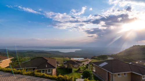a view of a lake from a residential neighbourhood at Lake Elementaita Mountain Lodge in Nakuru