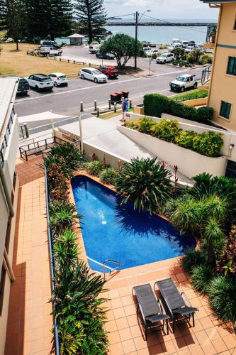 an overhead view of a swimming pool in a building at Yamba Beach Motel in Yamba