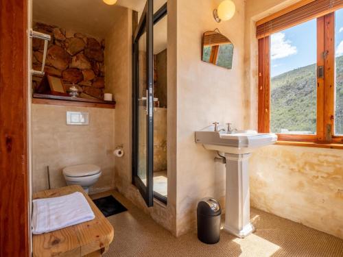 a bathroom with a sink and a toilet and a window at Die Beloofde Land in Uniondale