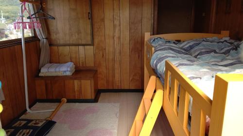 a small bedroom with a bed and a window at Guesthouse Yashima in Takamatsu