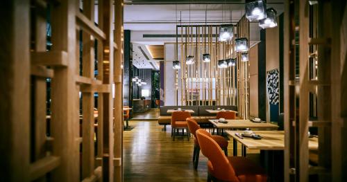 a restaurant with chairs and tables in a room at EQ Kuala Lumpur in Kuala Lumpur