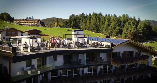 a group of people standing on the balcony of a hotel at Hotel Scherlin in Ortisei