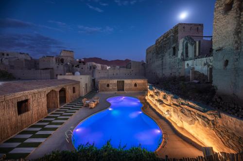 a large swimming pool in a building at night at Antique Inn in Nizwa