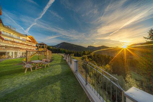a balcony of a building with a view of the mountains at Hotel Scherlin in Ortisei