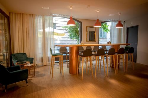 a dining room with a table and chairs at Hôtel Le Rohan, centre Cathédrale in Strasbourg