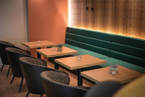 a row of tables and chairs in a restaurant at Hôtel Le Rohan, centre Cathédrale in Strasbourg