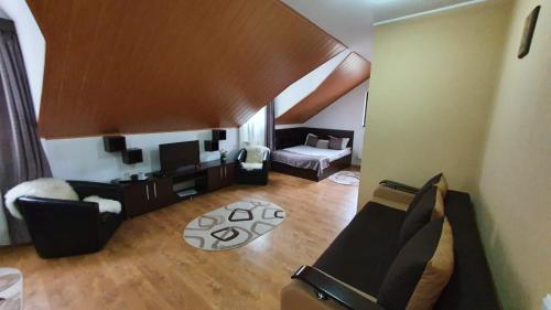 a living room with a couch and a table at Casa Teleferic in Buşteni