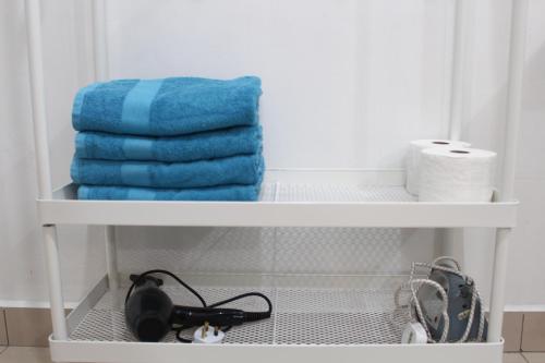 a shelf with towels and toilet paper in a bathroom at One O' Three Studio Apartment @D'Perdana Kota Bharu in Kota Bharu