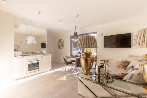 a living room with a couch and a table at Apartament Prestige & Sea Balticus A4 in Międzyzdroje