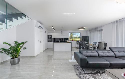 a living room with a black couch and a kitchen at Villa Sandi in Novigrad Istria