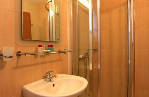 a bathroom with a sink and a shower at Ski Villa in Pamporovo Forest in Pamporovo