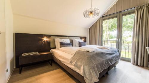 Säng eller sängar i ett rum på Dormio Resort Maastricht