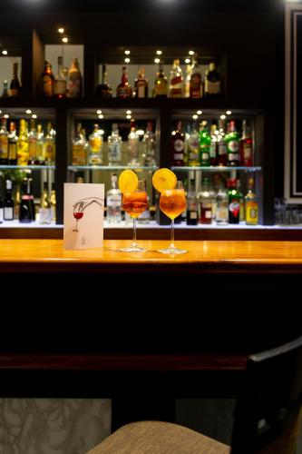 a bar with two cocktails sitting on a counter at Hotel Principe Torlonia in Rome