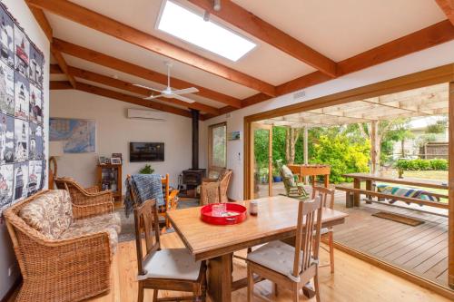 a dining room with a table and chairs at Merricks Surf Cottage - Charming Beachfront Bliss in Merricks