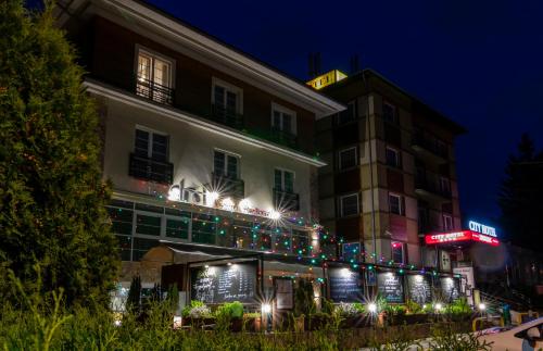 a hotel building with christmas lights on it at City Hotel Miskolc in Miskolc