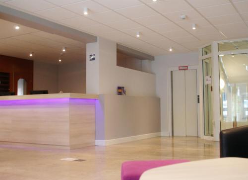 an empty room with purple lights on a wall at Taste Hotel Hockenheim in Hockenheim