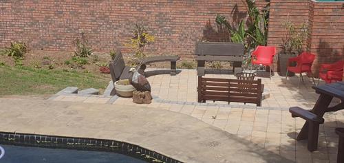a patio with a bird statue next to a pool at Bon A Vie Self-catering and b&b Gonubie Full Solar Power, no load shedding! in Gonubie