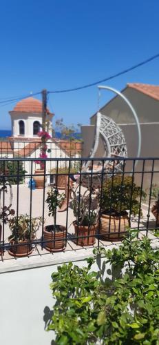 a balcony with potted plants on a building at Villa Aposperitis in Panormos Rethymno