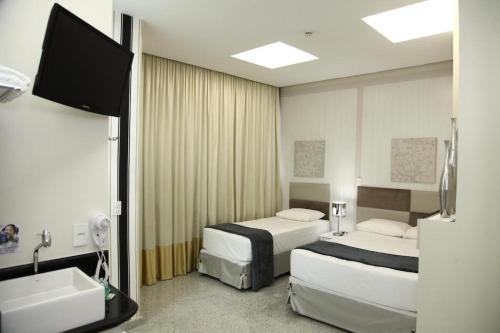 Ένα ή περισσότερα κρεβάτια σε δωμάτιο στο Compacto Hotel