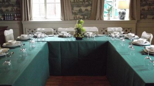 a large blue table with wine glasses on it at Hadley Bowling Green Inn in Droitwich