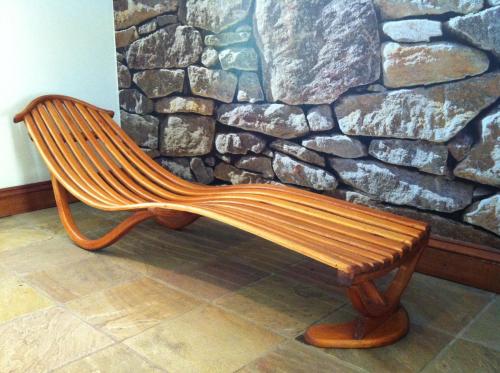 a wooden bench sitting in front of a stone wall at Barbados 13, Caribbean Estate - PRIVATE POOL!! in Port Edward