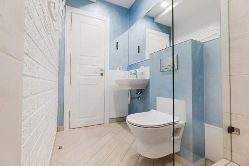 a bathroom with a toilet and a sink at CityApartments Kyiv Palace "Ukraine" in Kyiv