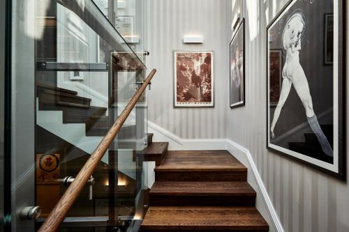a staircase leading up to a room with a painting on the wall at Teatro Hotel in Warsaw