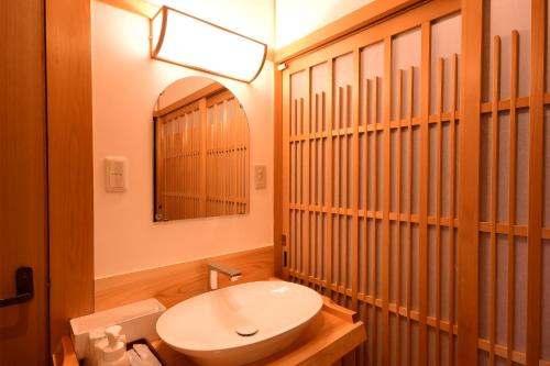 a bathroom with a toilet and a sink and a mirror at 高野山 宿坊 不動院 -Koyasan Shukubo Fudoin- in Koyasan