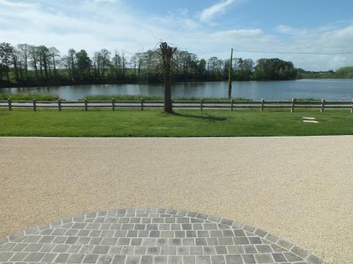 two photographs of a park with a body of water at Chambre d'Hôtes - La Rigaudière in Le Theil-de-Bretagne