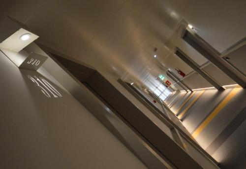 an empty hallway with an escalator in a building at Hotel Friuli in Udine
