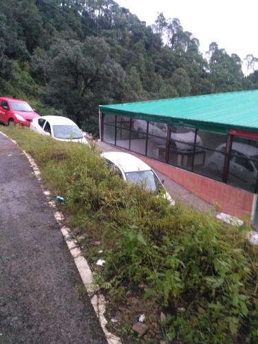 a group of cars parked next to a building at Maavaa Dreamland in Lansdowne