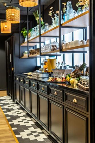 a kitchen with a counter with dishes on it at Mercure La Roche Sur Yon in La Roche-sur-Yon