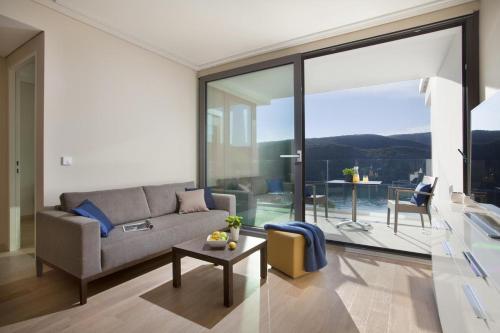 a living room with a couch and a table at Park Hill Residences in Rabac