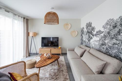 a living room with a couch and a table at Maison Elleviou - Grande Maison à deux pas du centre in Rennes